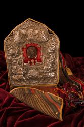 Ga’u (portable altar or amulet box), tsa tsa (votive offering with sacred image) featuring Avolokiteshevara, wood block printed prayer flags, and carrying case