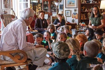 J. Paul Taylor reads to children at his Mesilla Home (contemporary, year & photographer unknown)