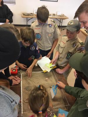 11-LOA - 2018 A troop of Boy Scouts learning how to excavate and record archaeological discoveries in MIACs Dig Box. Photographer: Amy Montoya. Photo Courtesy of Museum of Indian Arts & Culture