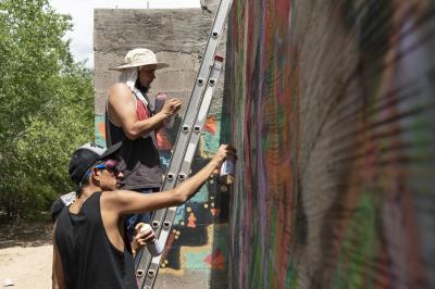 2-MOIFA-Gallery of Conscience Fernando Castro of Amapolay and Juan Lira painting at artist collective Alas de Agua’s mural site in Santa Fe, June 27th, 2018  Photographer: Chloe Accardi 