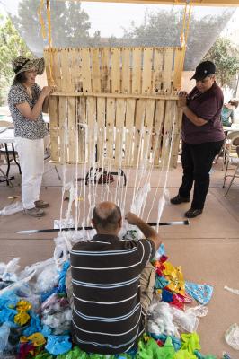 2-MOIFA-Gallery of Conscience: Aymar Ccopacatty working on the community trash loom at MOIFA during the Arts Alive program, August 2nd 2018  Photographer: Chloe Accardi 